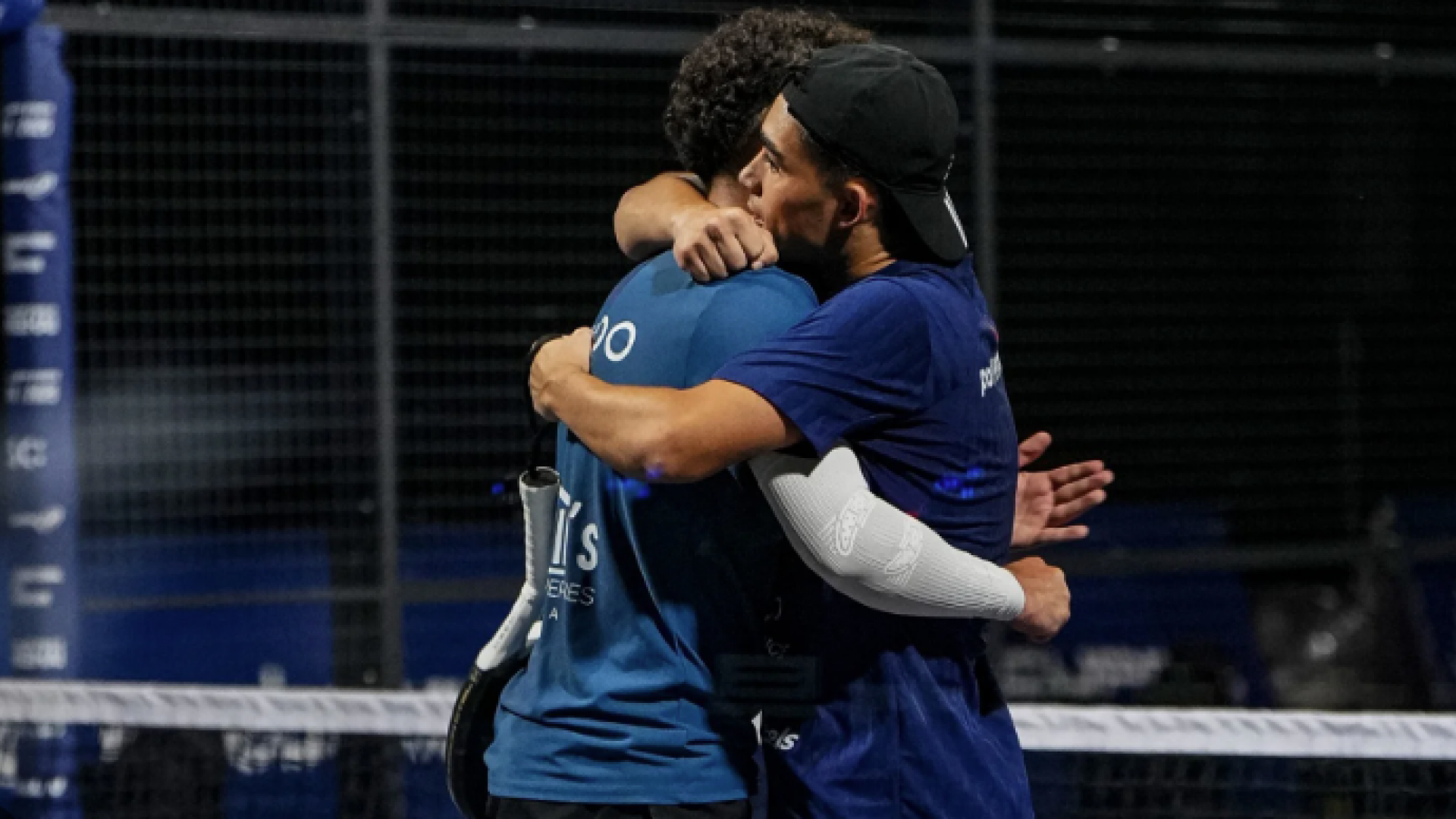 Sportsmanship on the Court A close-up of two padel players hugging at the end of a match, showing sportsmanship and mutual respect on the court.